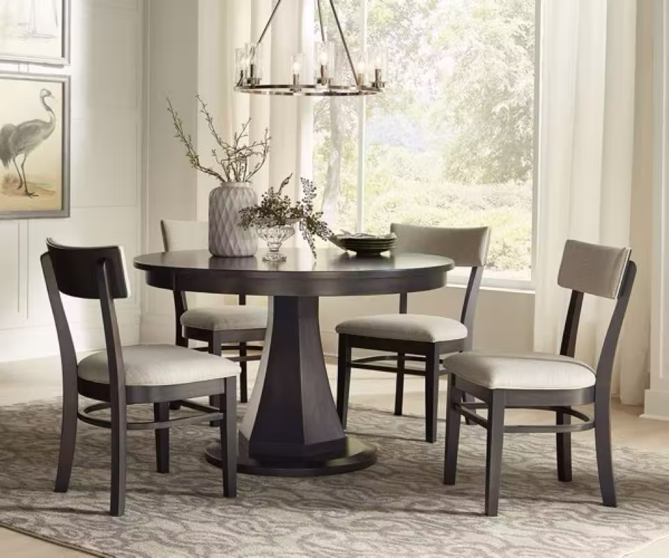 Contemporary Amish dining set with dark pedestal table and upholstered chairs